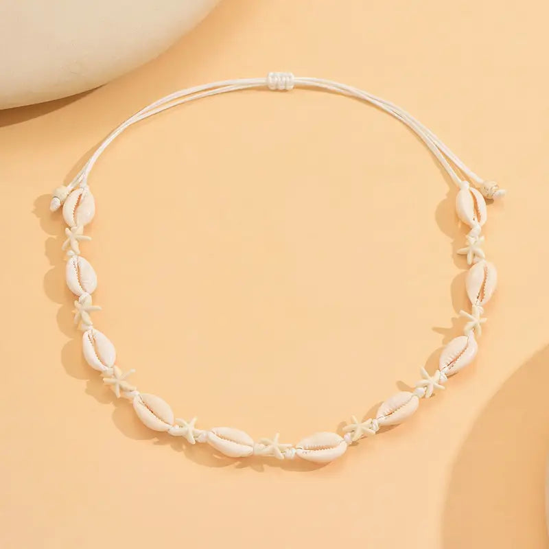 Necklace with shell-like beads on a beige background