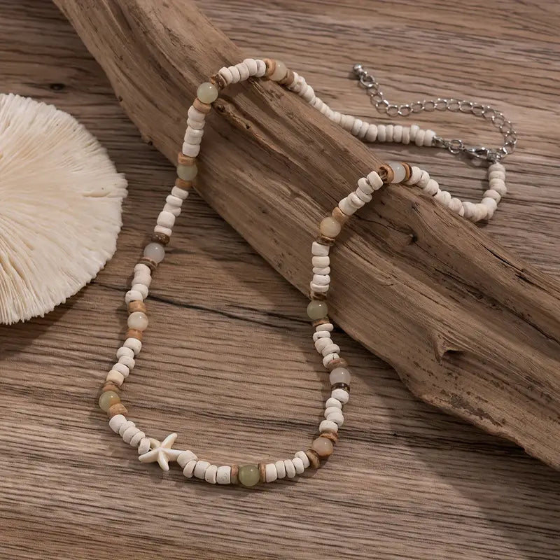 Necklace with starfish charm on a wooden surface