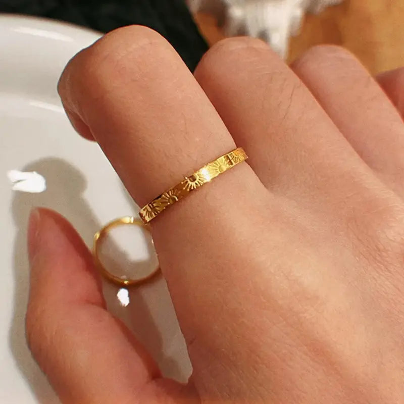 Gold ring on a finger with a blurred background