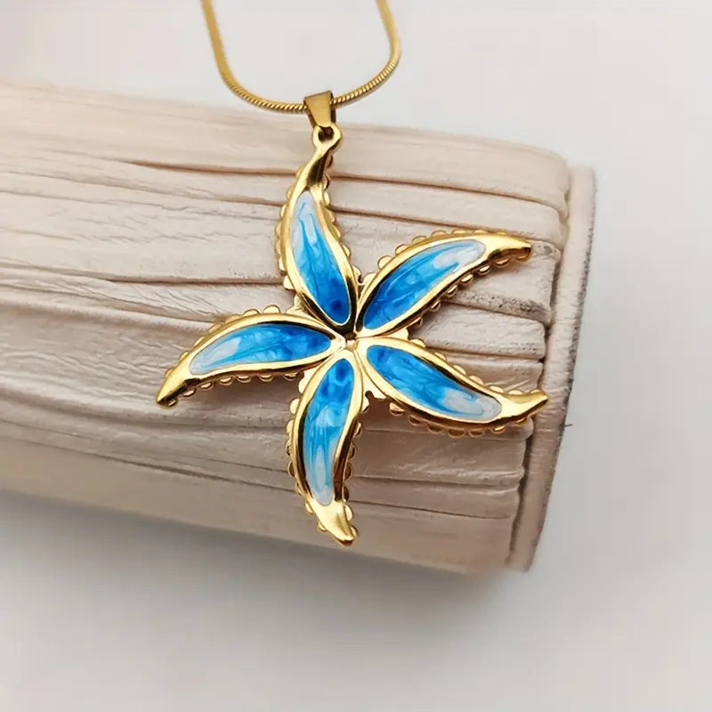 Blue starfish pendant on a gold chain 