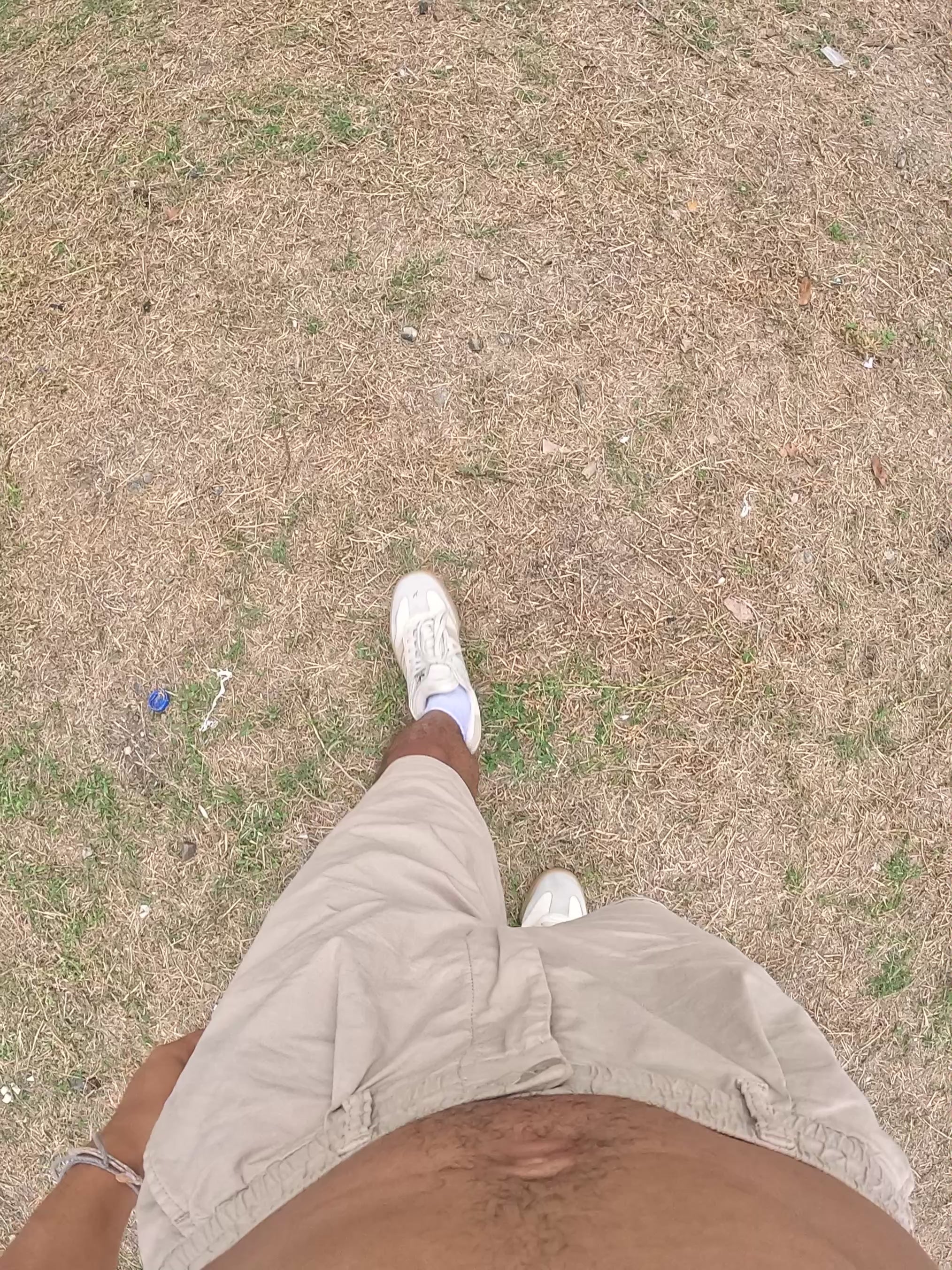 man picking up hanging tshirt in backyard